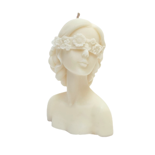 vela de soya en forma de rostro de mujer con ojos tapados